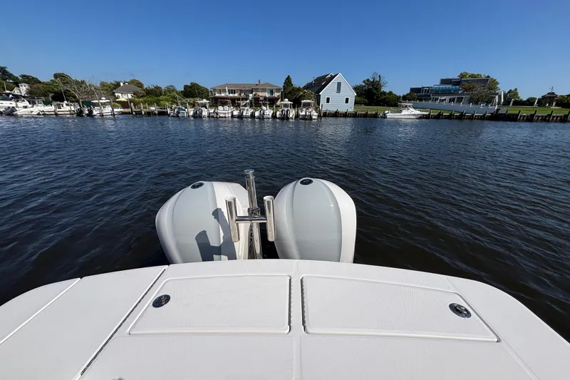  Yacht Photos Pics 2017 Regulator 28 boat with dual engines on a calm waterfront.