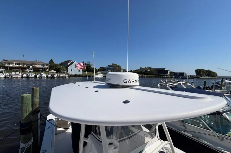  Yacht Photos Pics 2017 Regulator 28 boat docked, featuring Garmin radar, American flag, and waterfront view.
