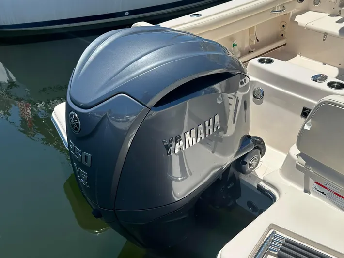  Yacht Photos Pics 2023 Grady-White Adventure 218 with Yamaha outboard motor, docked on calm water.