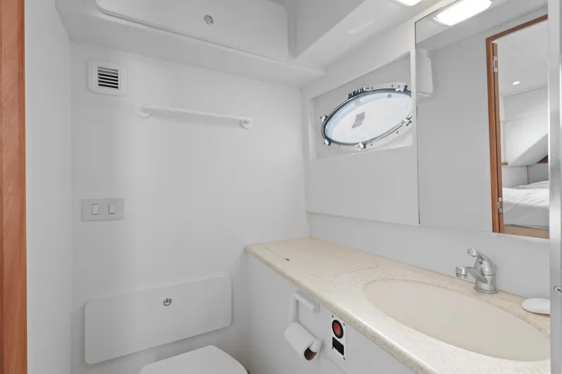  Yacht Photos Pics Bathroom interior of 2000 Silverton 392 Motor Yacht with sink and porthole window.