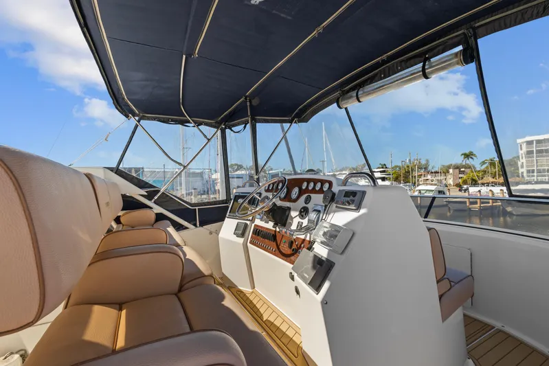  Yacht Photos Pics 2000 Silverton 392 Motor Yacht helm with tan seating and marina view.