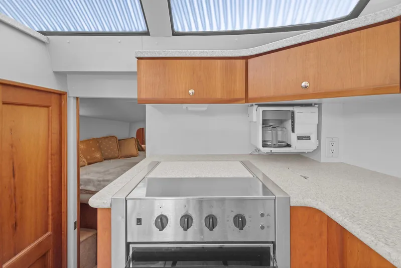  Yacht Photos Pics Interior of 2000 Silverton 392 Motor Yacht kitchen with stove and cabinets.