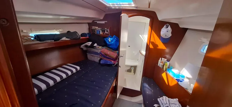  Yacht Photos Pics Cabin interior of 2006 Beneteau Oceanis Clipper 393 with cozy beds and wooden finish.