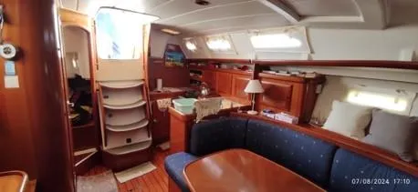  Yacht Photos Pics Interior of 2006 Beneteau Oceanis Clipper 393 yacht, featuring cozy seating and wooden finishes.