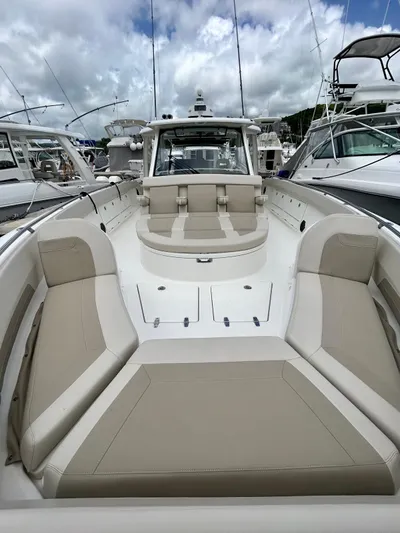  Yacht Photos Pics 2019 Boston Whaler 420 Outrage boat with spacious seating, docked at a marina.