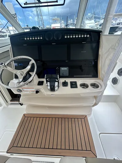  Yacht Photos Pics 2019 Boston Whaler 420 Outrage helm with advanced navigation controls and wooden flooring.