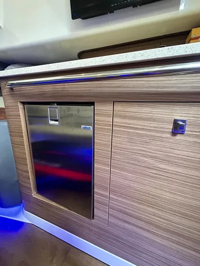  Yacht Photos Pics 2019 Boston Whaler 420 Outrage interior with wood finish and stainless steel accents.