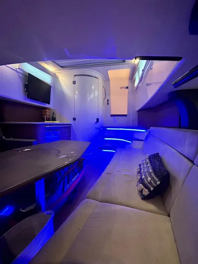  Yacht Photos Pics Interior of 2019 Boston Whaler 420 Outrage with modern seating and ambient blue lighting.