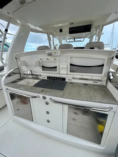  Yacht Photos Pics 2019 Boston Whaler 420 Outrage boat interior with modern kitchen amenities.