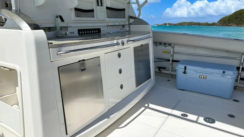  Yacht Photos Pics 2019 Boston Whaler 420 Outrage boat interior with stainless steel kitchen and ocean view.