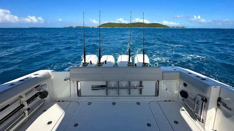  Yacht Photos Pics 2019 Boston Whaler 420 Outrage boat with fishing rods, cruising on open sea.