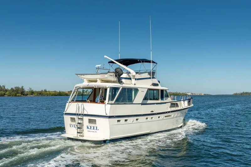 Even Keel Yacht Photos Pics 1985 Hatteras 53 Motor Yacht cruising on a sunny day, rear view.