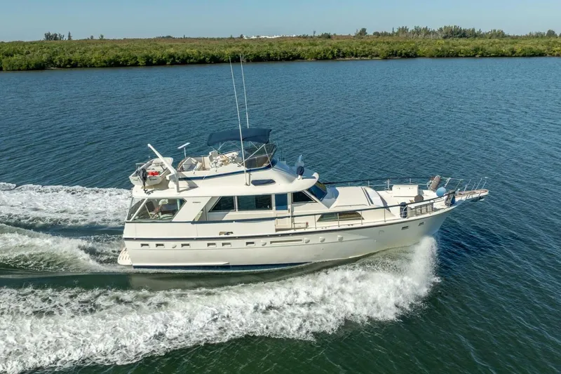 Even Keel Yacht Photos Pics 1985 Hatteras 53 Motor Yacht cruising on a serene waterway.