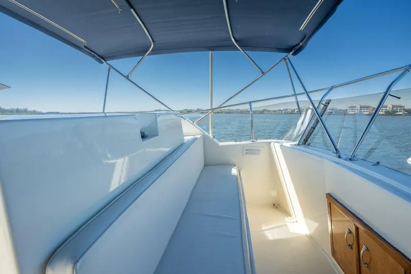 Even Keel Yacht Photos Pics 1985 Hatteras 53 Motor Yacht interior with cushioned seating and blue canopy.