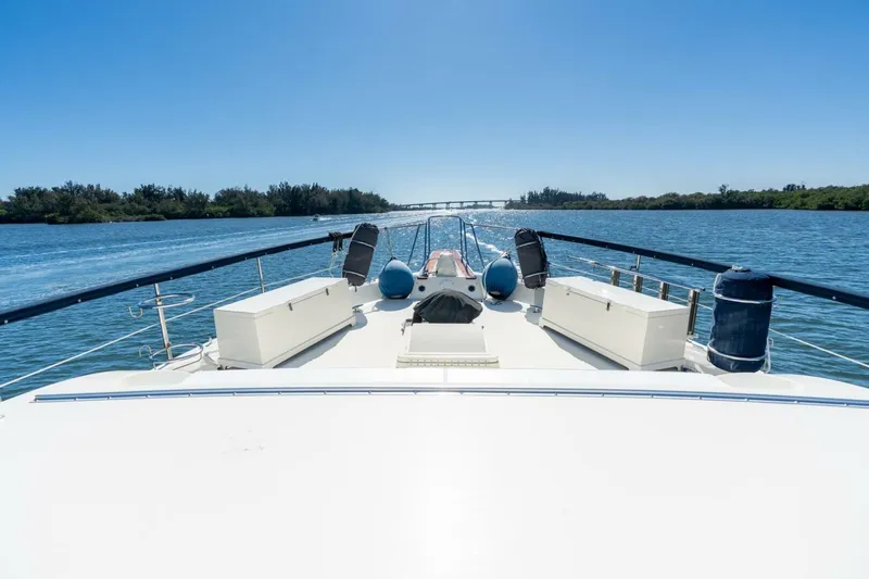 Even Keel Yacht Photos Pics 1985 Hatteras 53 Motor Yacht cruising on a sunny day, with clear blue skies and calm waters.
