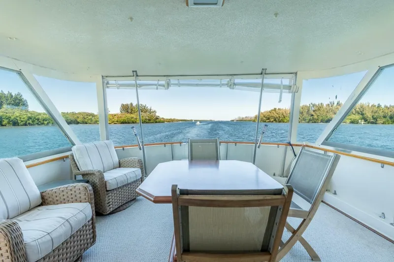 Even Keel Yacht Photos Pics 1985 Hatteras 53 Motor Yacht interior with scenic water view and comfortable seating.