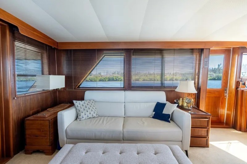 Even Keel Yacht Photos Pics Interior of 1985 Hatteras 53 Motor Yacht with elegant wood paneling and cozy seating.