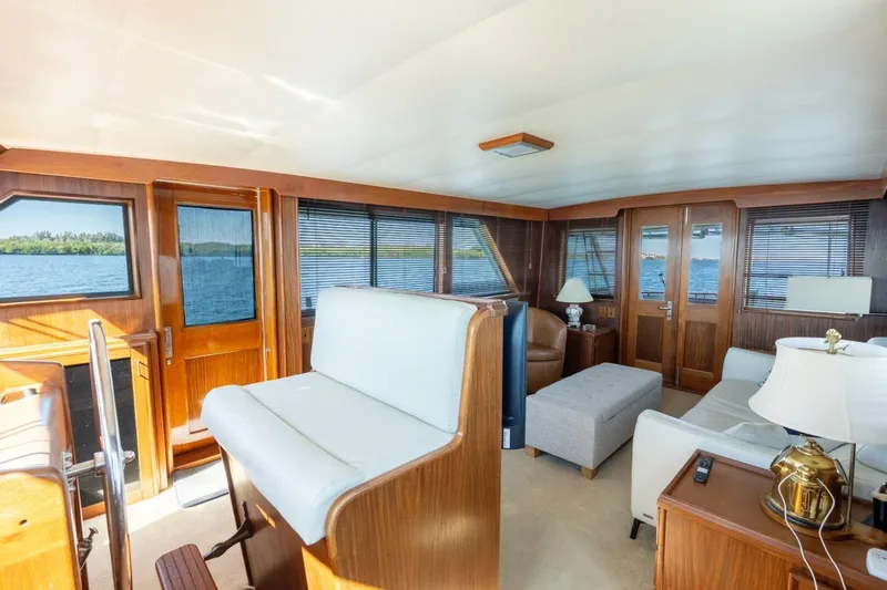 Even Keel Yacht Photos Pics Interior of 1985 Hatteras 53 Motor Yacht with elegant wood paneling and comfortable seating.