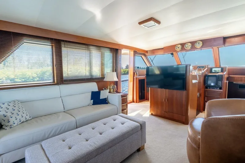 Even Keel Yacht Photos Pics Luxurious interior of 1985 Hatteras 53 Motor Yacht with elegant furnishings and panoramic windows.