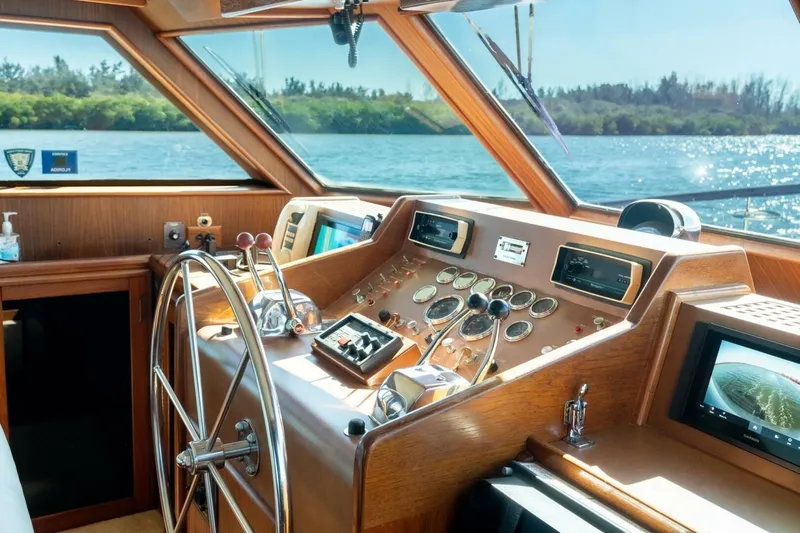 Even Keel Yacht Photos Pics 1985 Hatteras 53 Motor Yacht helm with classic wooden dashboard and steering wheel.