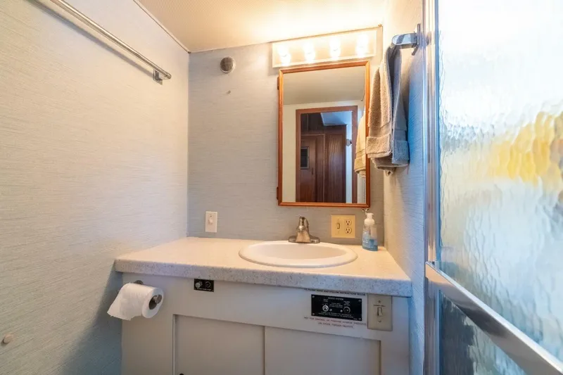 Even Keel Yacht Photos Pics Bathroom vanity in 1985 Hatteras 53 Motor Yacht with mirror and sink.