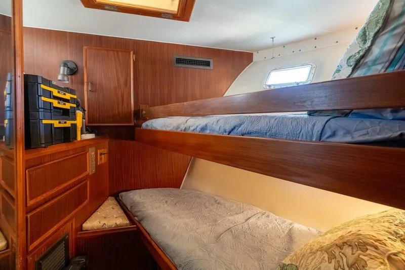 Even Keel Yacht Photos Pics Interior of 1985 Hatteras 53 Motor Yacht with wooden bunk beds and storage.