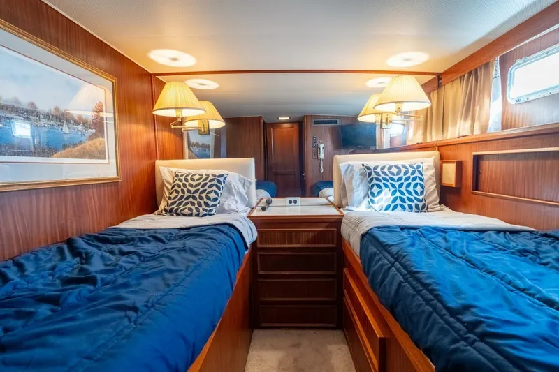 Even Keel Yacht Photos Pics Interior of 1985 Hatteras 53 Motor Yacht with twin beds and elegant wood paneling.