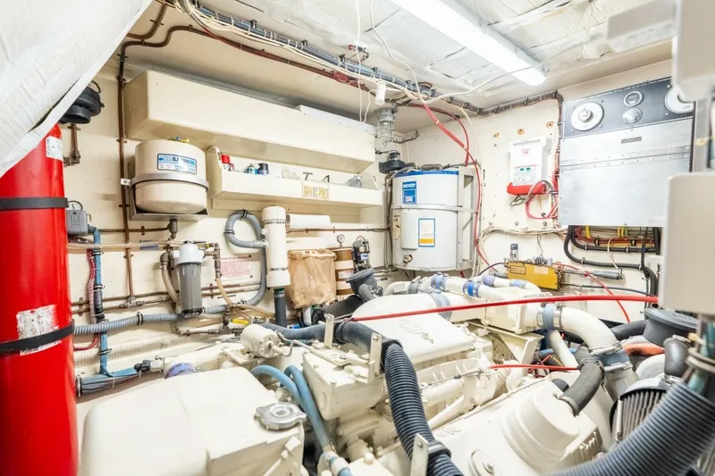 Even Keel Yacht Photos Pics Engine room of 1985 Hatteras 53 Motor Yacht, featuring complex machinery and piping.