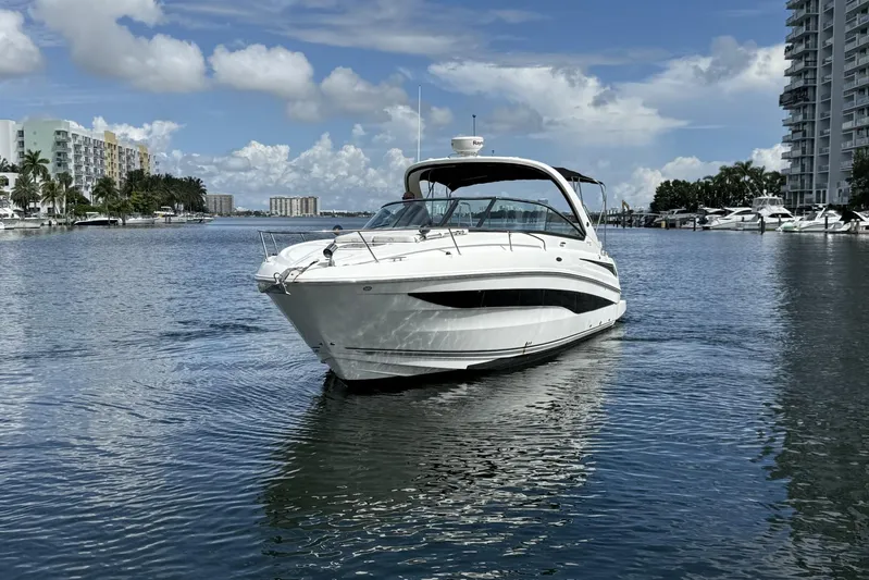  Yacht Photos Pics 2015 Sea Ray 370 Venture yacht cruising in a scenic waterfront setting.