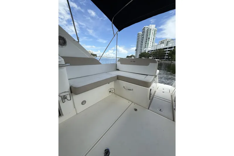  Yacht Photos Pics 2015 Sea Ray 370 Venture boat interior with seating, docked near modern buildings.