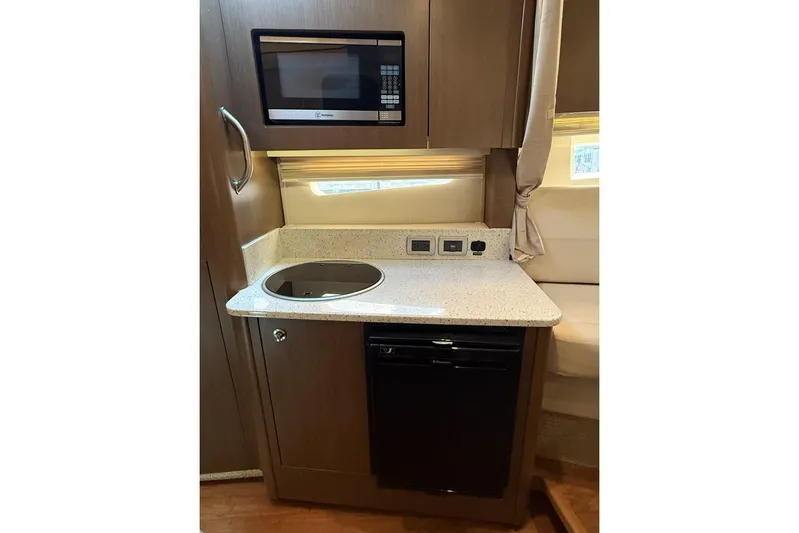  Yacht Photos Pics 2015 Sea Ray 370 Venture galley with microwave, cooktop, and compact fridge.