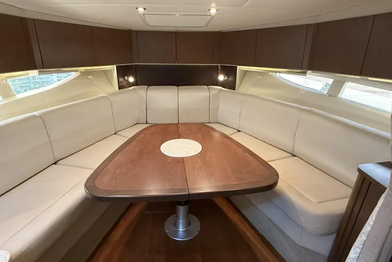  Yacht Photos Pics Luxurious interior of 2015 Sea Ray 370 Venture yacht with elegant seating and wooden table.