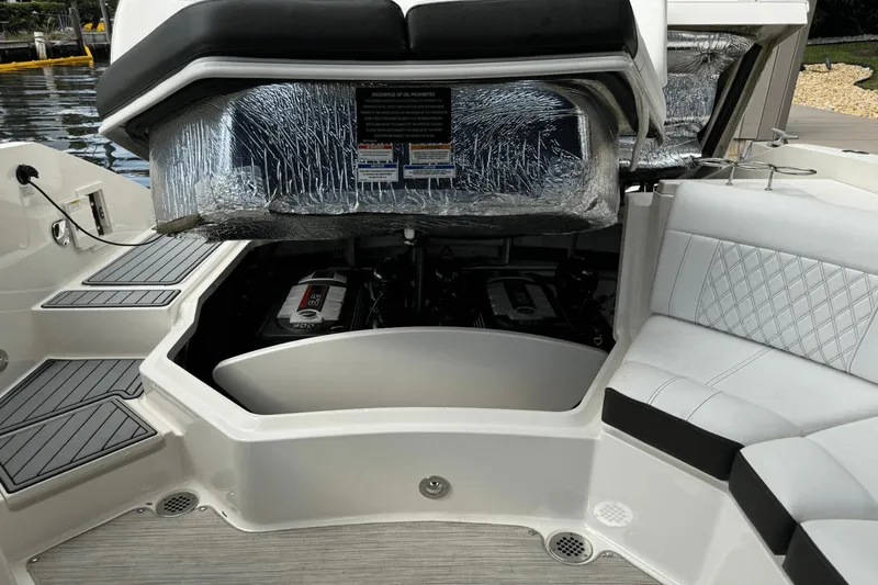  Yacht Photos Pics 2019 Sea Ray 310 SLX boat engine compartment with open hatch and cushioned seating.