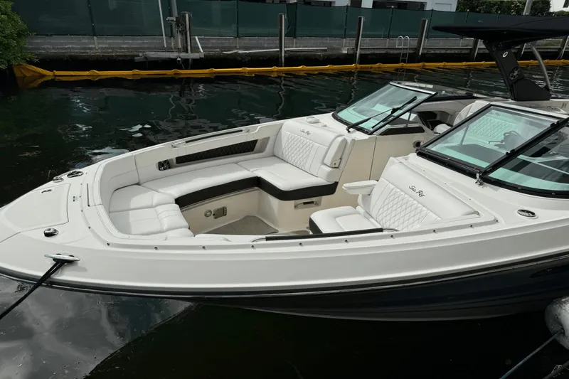  Yacht Photos Pics 2019 Sea Ray 310 SLX boat with luxurious white seating, docked in calm waters.