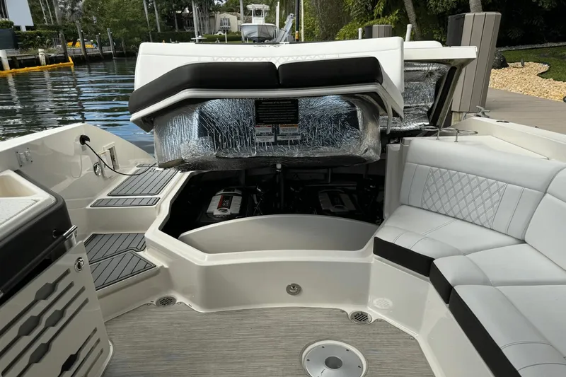  Yacht Photos Pics 2019 Sea Ray 310 SLX boat interior with open engine compartment, docked by the water.