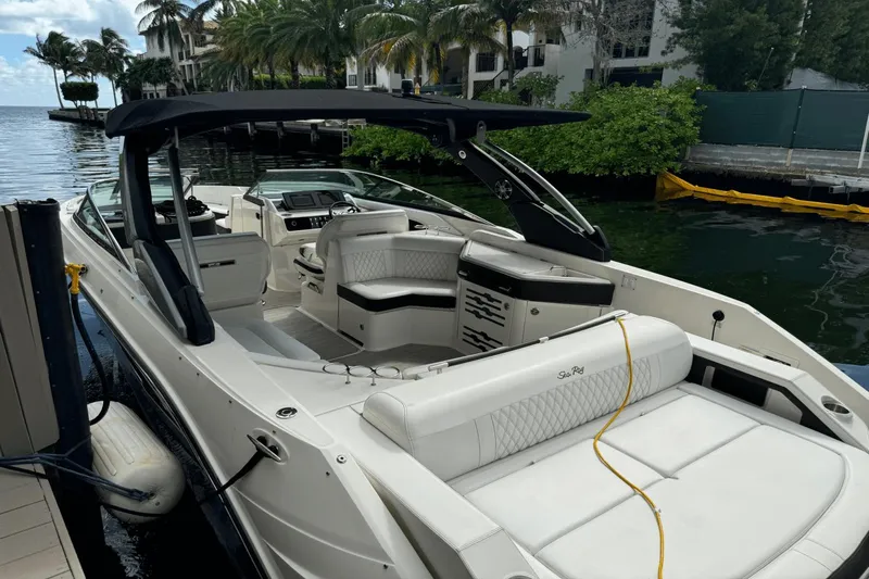  Yacht Photos Pics 2019 Sea Ray 310 SLX luxury boat docked by palm trees and waterfront homes.