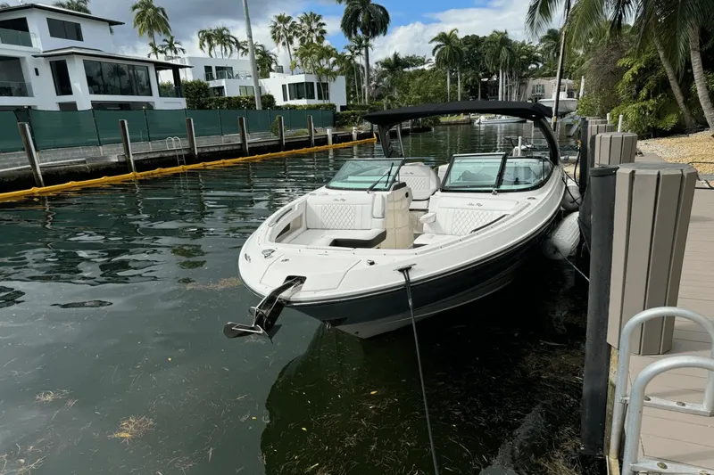  Yacht Photos Pics 2019 Sea Ray 310 SLX boat docked by waterfront homes with palm trees.