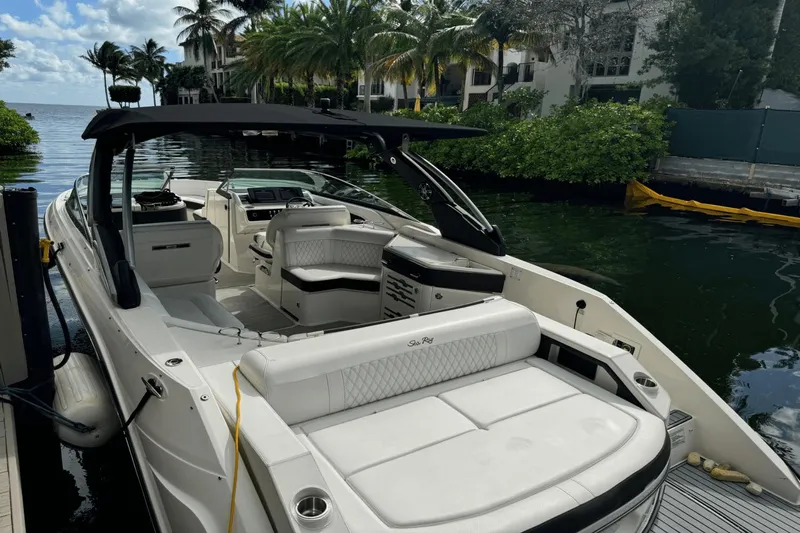  Yacht Photos Pics 2019 Sea Ray 310 SLX boat docked by lush waterfront.