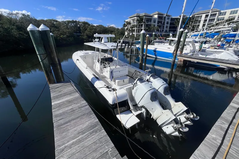  Yacht Photos Pics 2008 Intrepid 370 Cuddy boat docked in marina, clear sky, calm water.