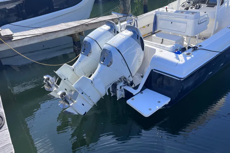  Yacht Photos Pics 2008 Intrepid 370 Cuddy boat with dual outboard engines docked in marina.