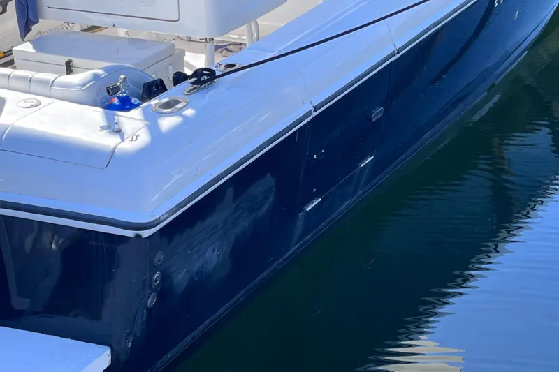  Yacht Photos Pics 2008 Intrepid 370 Cuddy boat, sleek design, docked on calm water.