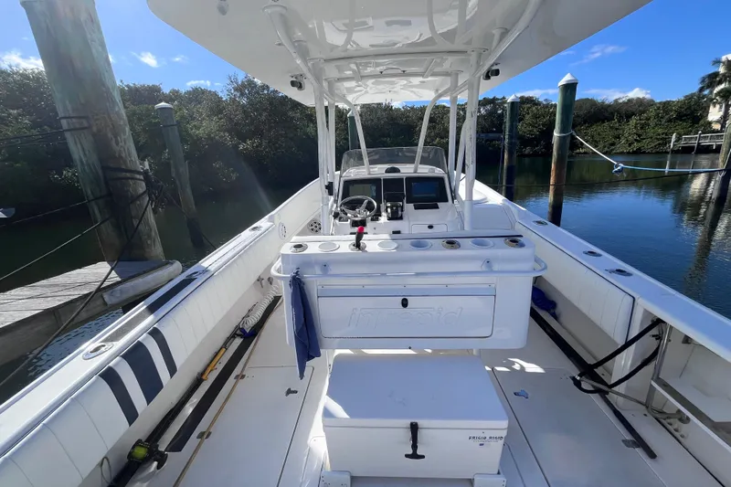 Yacht Photos Pics 2008 Intrepid 370 Cuddy boat interior with helm, docked by calm water.