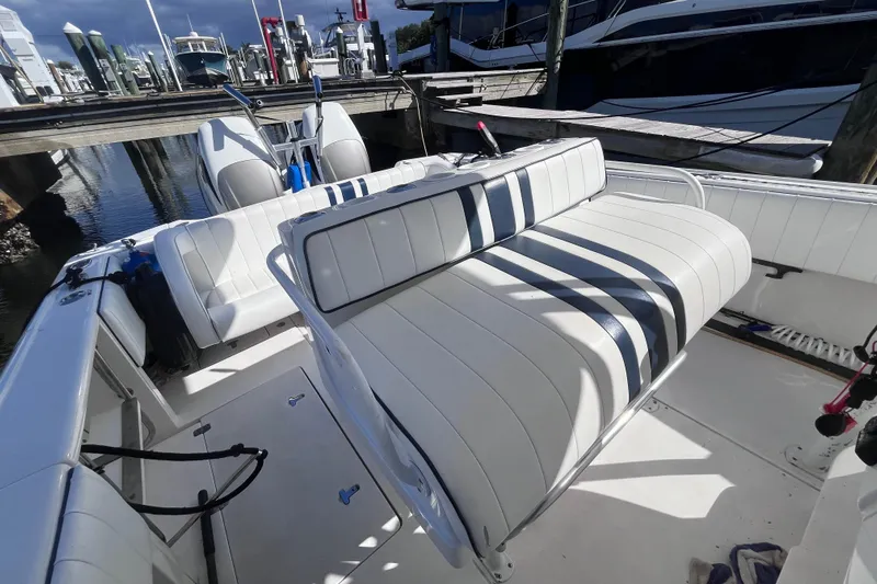  Yacht Photos Pics 2008 Intrepid 370 Cuddy boat interior with striped seating at marina.