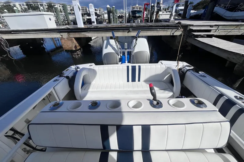  Yacht Photos Pics 2008 Intrepid 370 Cuddy boat interior with seating and cup holders at a marina.