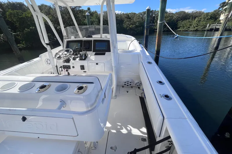  Yacht Photos Pics 2008 Intrepid 370 Cuddy boat interior with helm and seating, docked by water.
