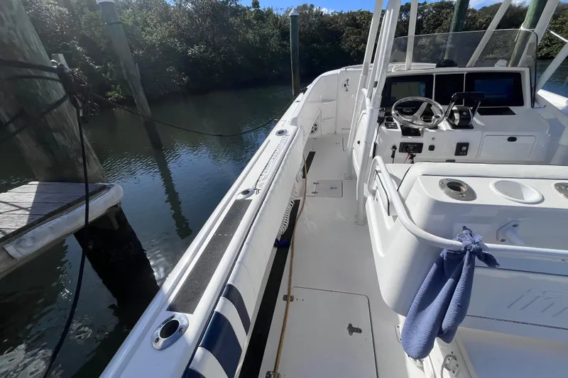  Yacht Photos Pics 2008 Intrepid 370 Cuddy boat interior with steering wheel and dock view.