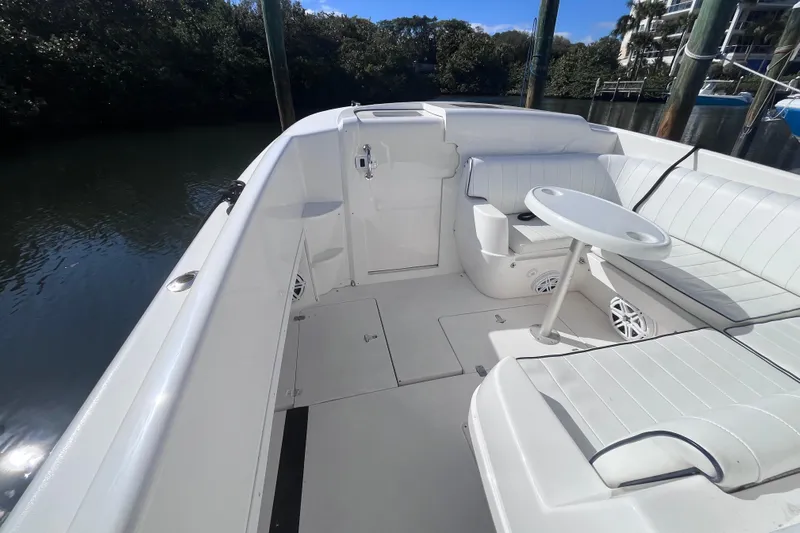  Yacht Photos Pics 2008 Intrepid 370 Cuddy boat interior with white seating and round table.