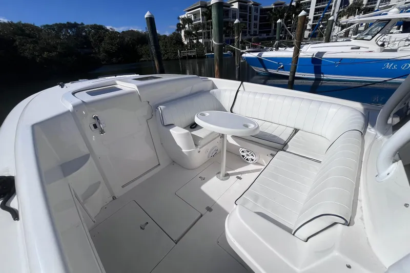  Yacht Photos Pics 2008 Intrepid 370 Cuddy boat interior with white seating and table, docked at marina.