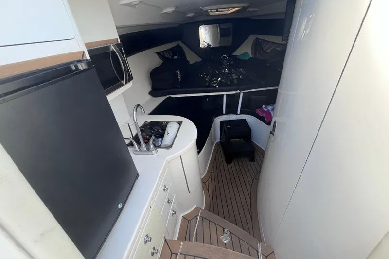  Yacht Photos Pics Interior of a 2008 Intrepid 370 Cuddy boat with kitchenette and sleeping area.