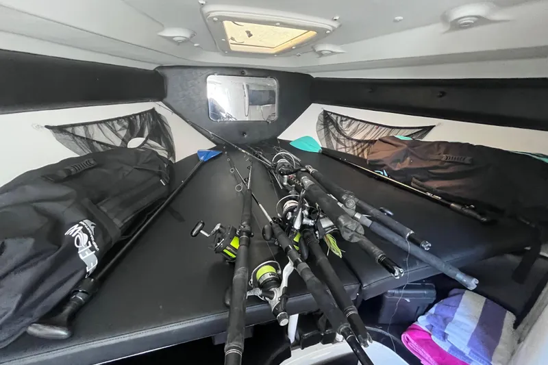  Yacht Photos Pics 2008 Intrepid 370 Cuddy cabin interior with fishing rods and gear.